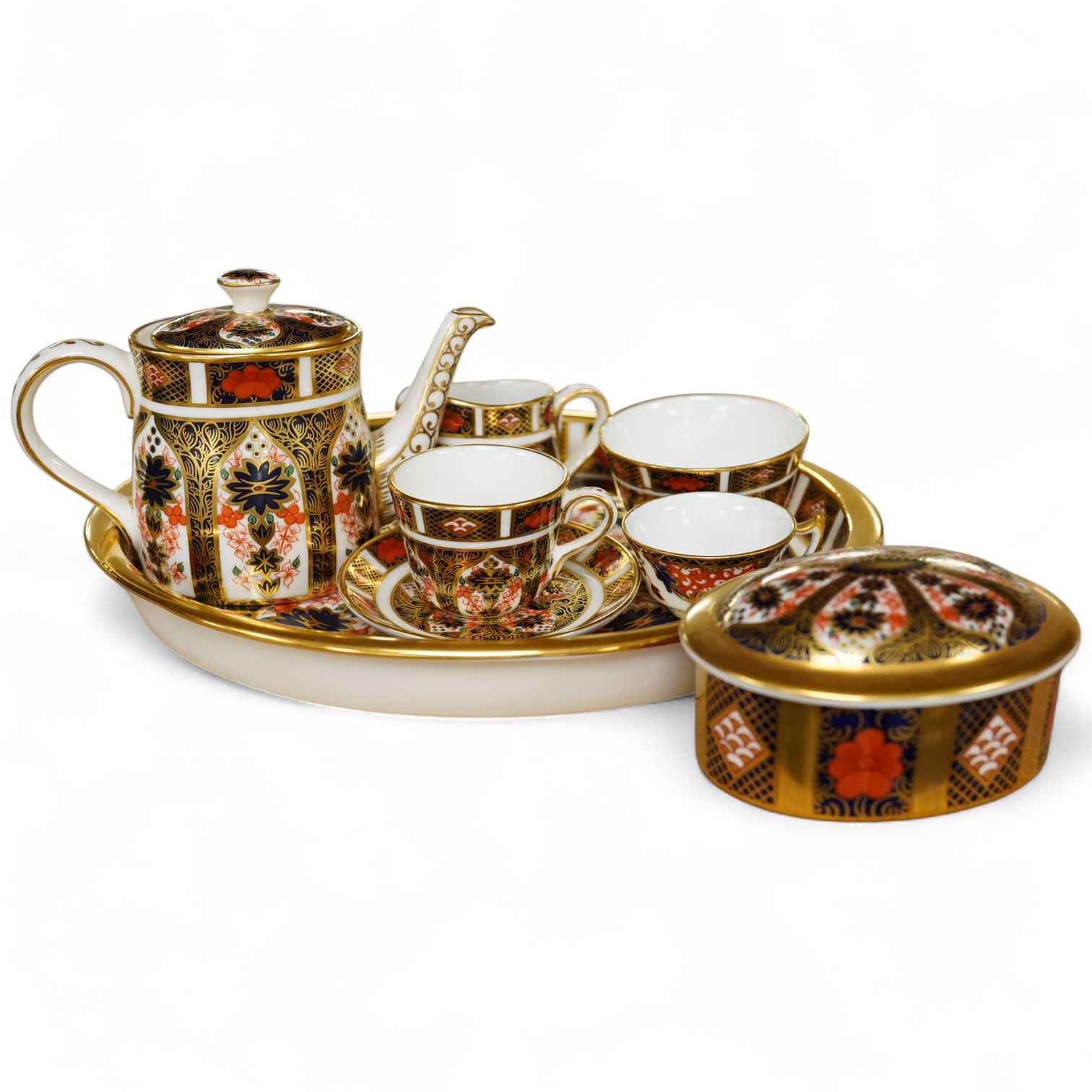 A small collection of Royal Crown Derby miniature tea for two and a pill box, tray 19cm wide. Saucer missing on tea for two.
